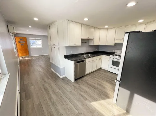 an empty room with a window and a ceiling fan