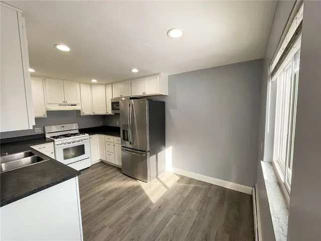 an empty room with a chandelier fan and closet