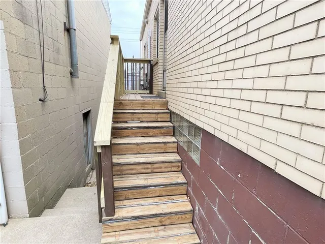 a kitchen with stainless steel appliances sink a stove and white cabinets