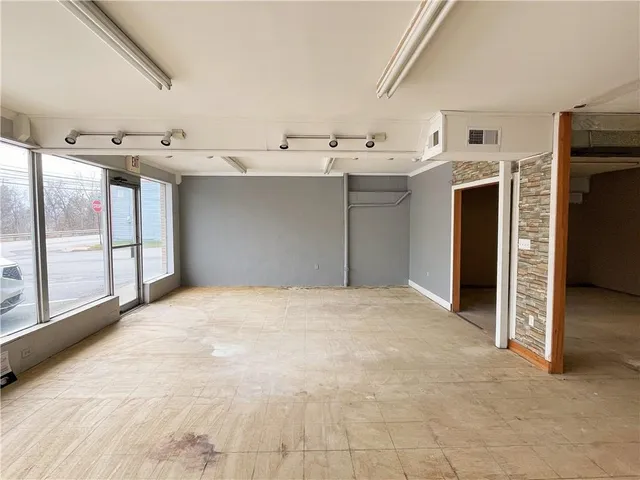 a view of a utility room with cabinets