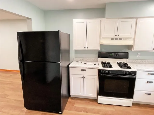 an empty room with closet and a chandelier fan
