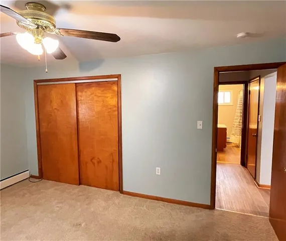 a view of a room with a window and a ceiling fan