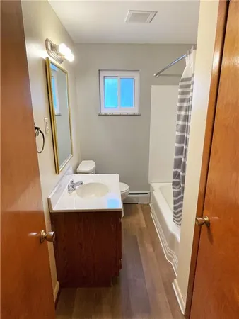 a utility room with dryer washer and a view of living room
