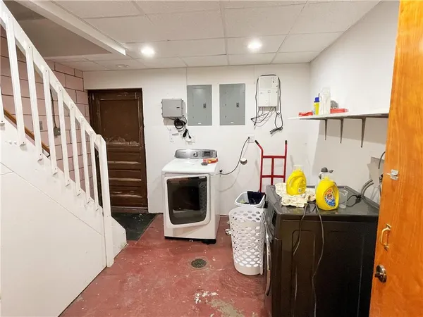 a kitchen with granite countertop a stove a sink and a refrigerator