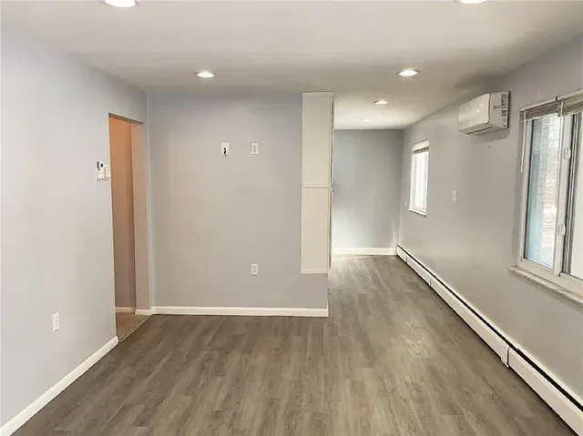 a kitchen with granite countertop a refrigerator and a stove top oven