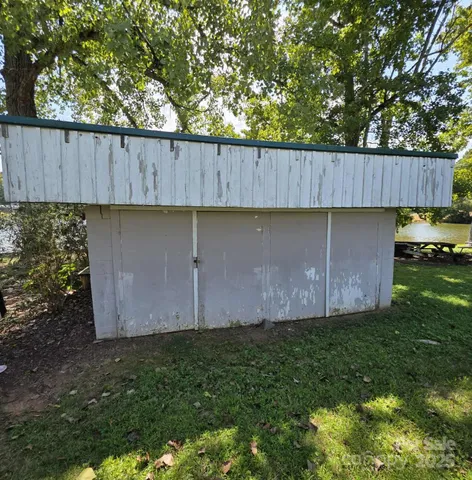 a view of backyard with potted plants and wooden fence