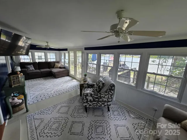 a living room with furniture fireplace and a large window