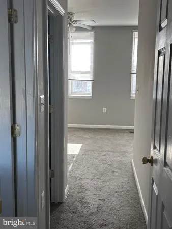a bathroom with a white toilet and a bathtub