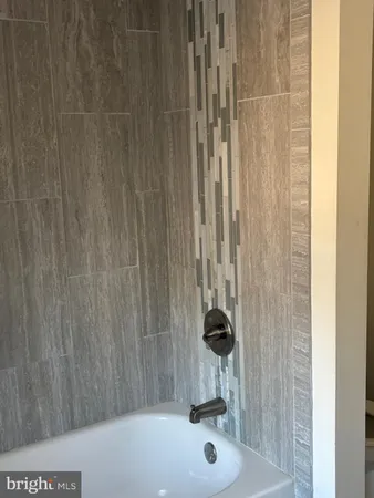 a white toilet sitting next to a shower