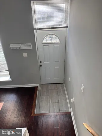 a view of walk in closet with wooden floor