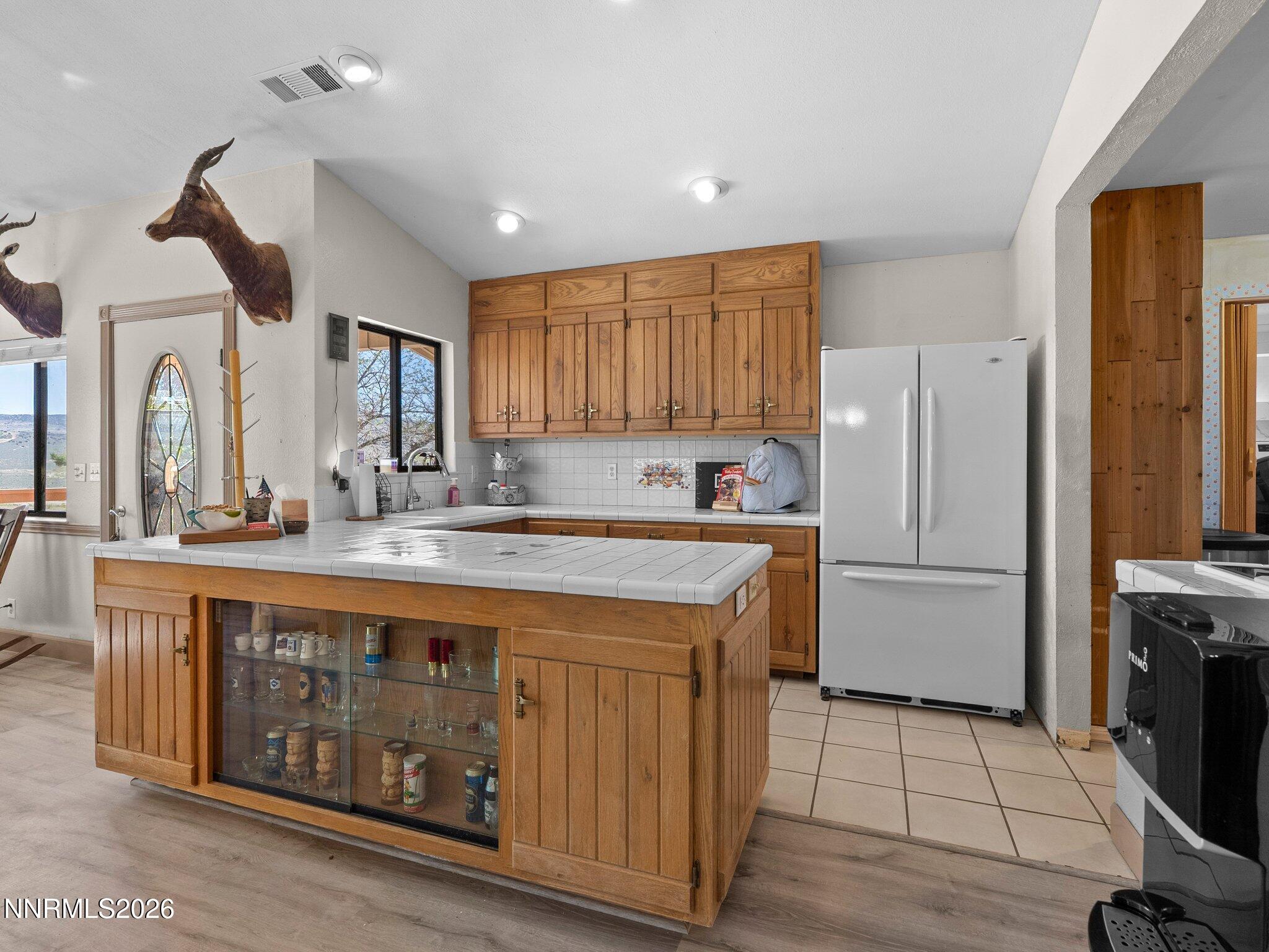 5500 Peak Road Reno, NV 89510 - Photo 16 of 56 a kitchen with stainless steel appliances granite countertop a refrigerator a sink dishwasher and a stove with wooden floor