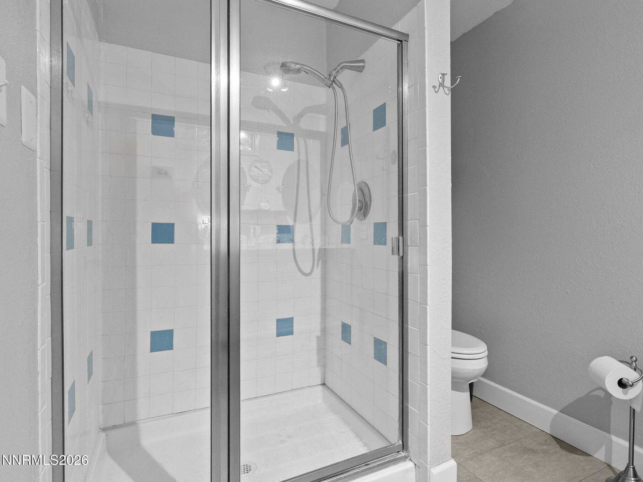5500 Peak Road Reno, NV 89510 - Photo 27 of 56 a bathroom with a glass shower door