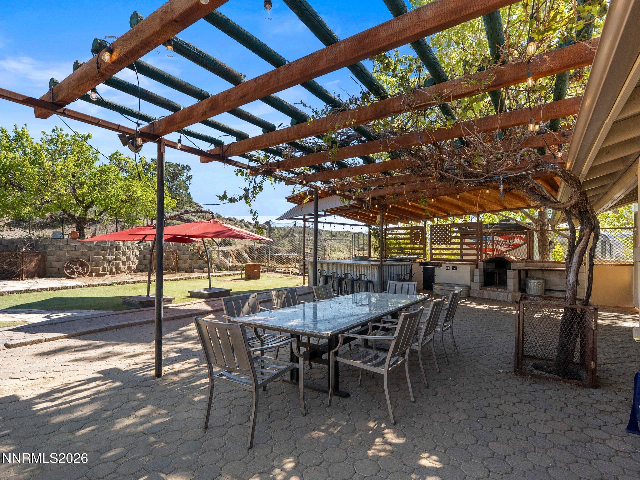 5500 Peak Road Reno, NV 89510 - Photo 37 of 56 a view of a patio with table and chairs with wooden floor and fence