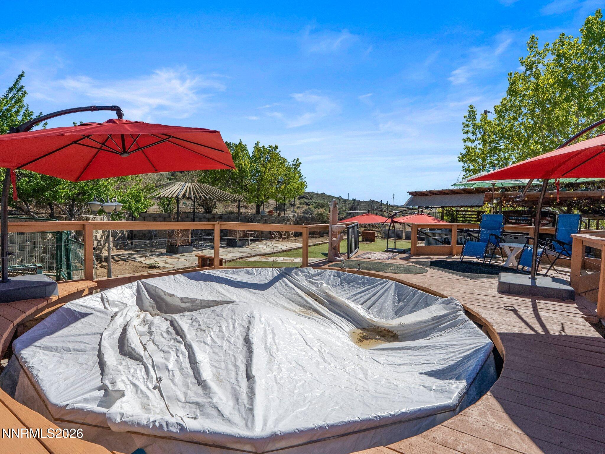 5500 Peak Road Reno, NV 89510 - Photo 44 of 56 a view of a swimming pool with red chairs in patio