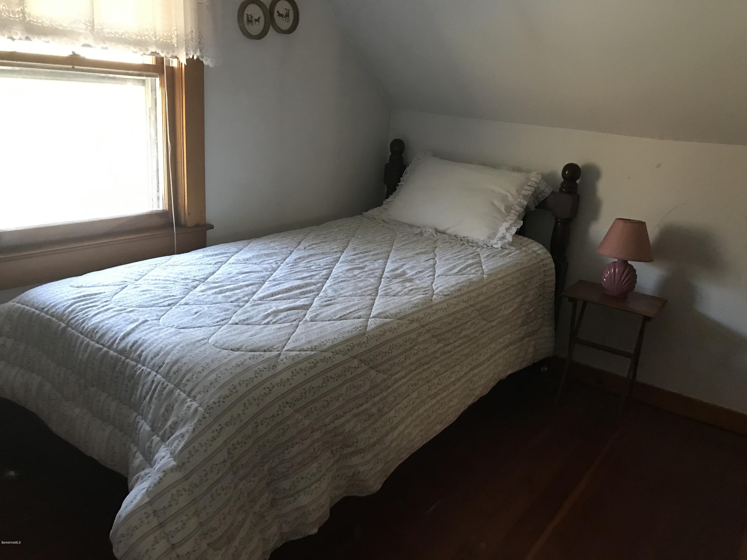 274 South County Road Florida, MA 01343 - Photo 13 of 16 a bed sitting in a bedroom next to a window