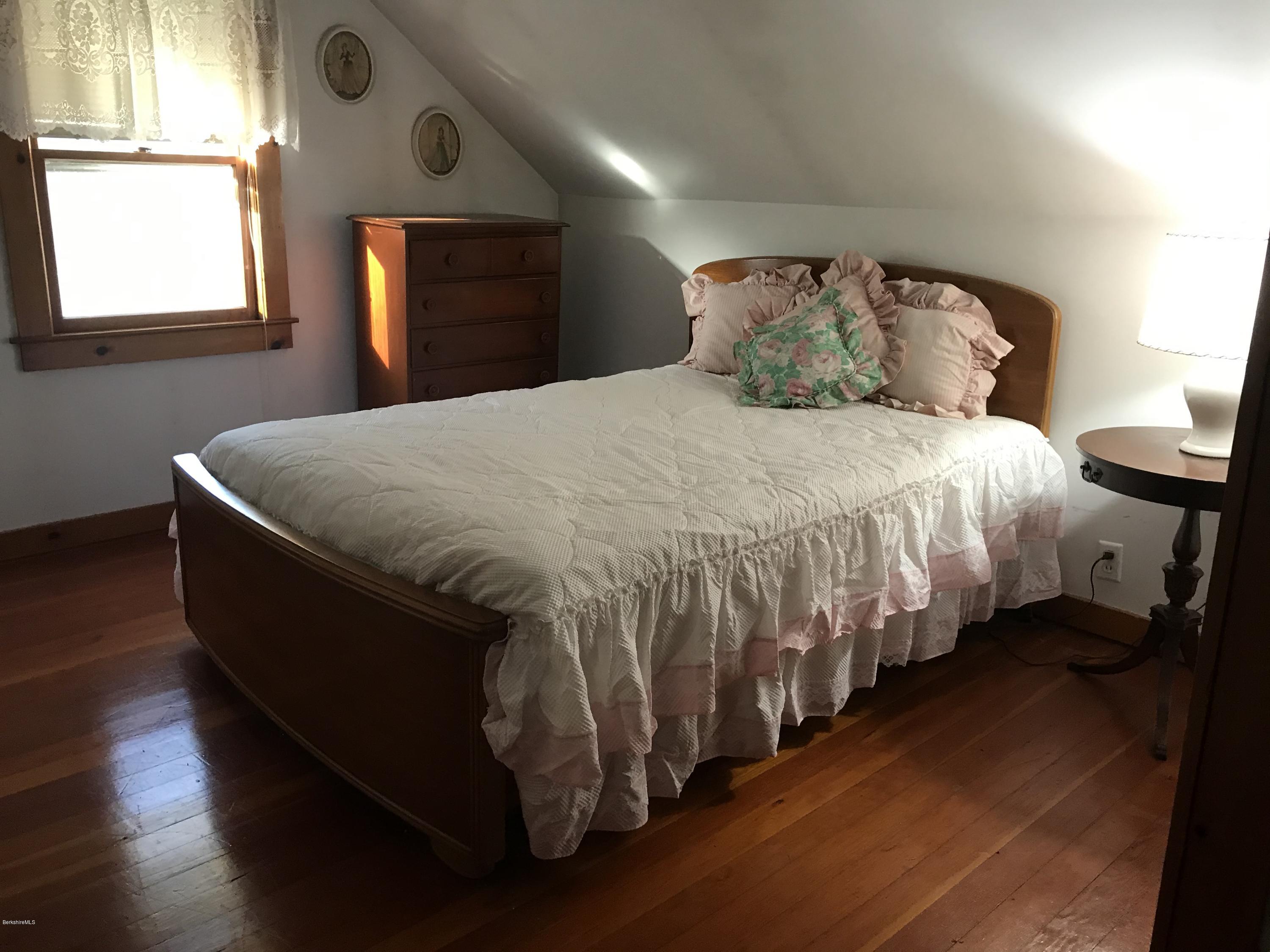 274 South County Road Florida, MA 01343 - Photo 10 of 16 a bed sitting in a bedroom next to a window
