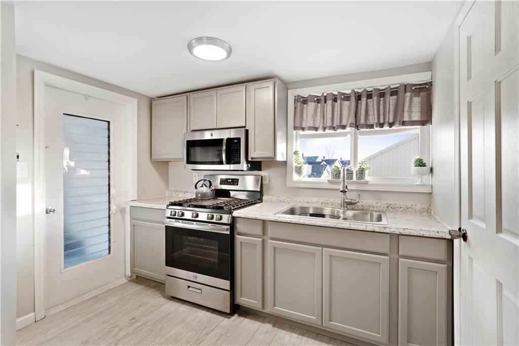 504 Oak Street Richeyville, PA 15358 - Photo 4 of 19 a kitchen with a sink stove and microwave