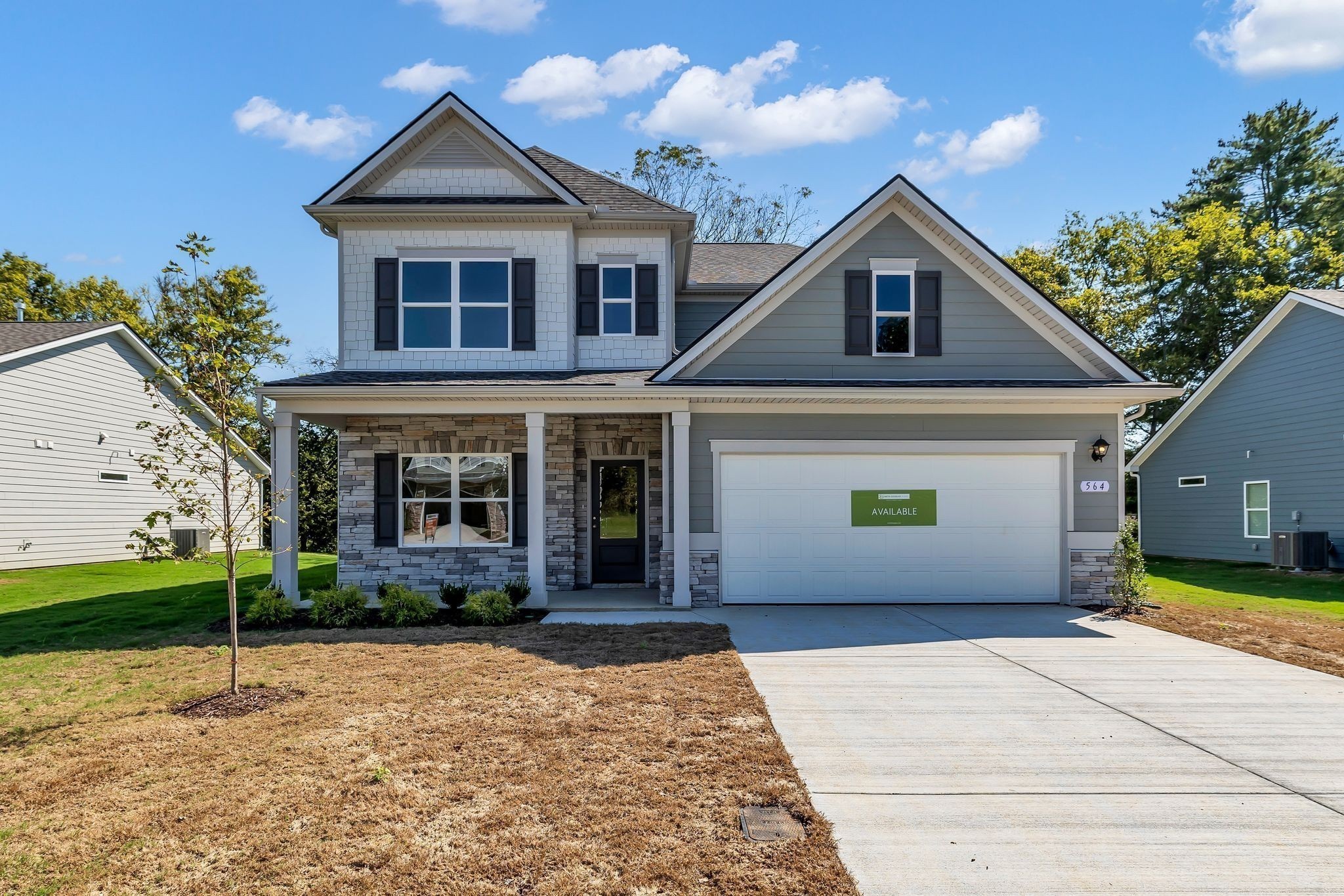 a front view of a house with a yard and garage
