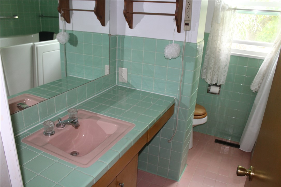 12735 Catlin Tilton Road Catlin, IL 61817 - Photo 16 of 22 a bathroom with a sink a toilet and shower