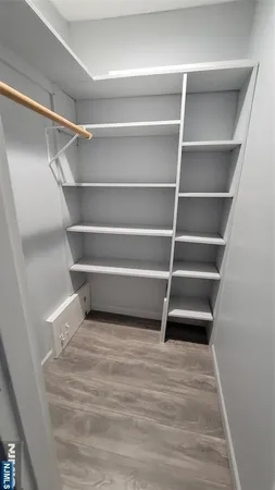 a view of walk in closet with empty racks