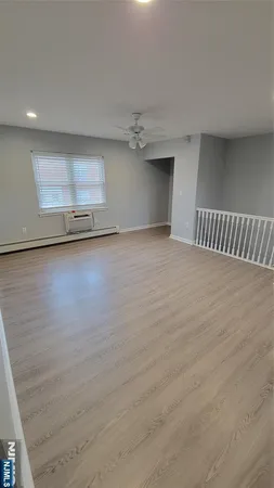 a view of a room with wooden floor