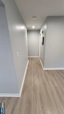 a view of hallway with wooden floor