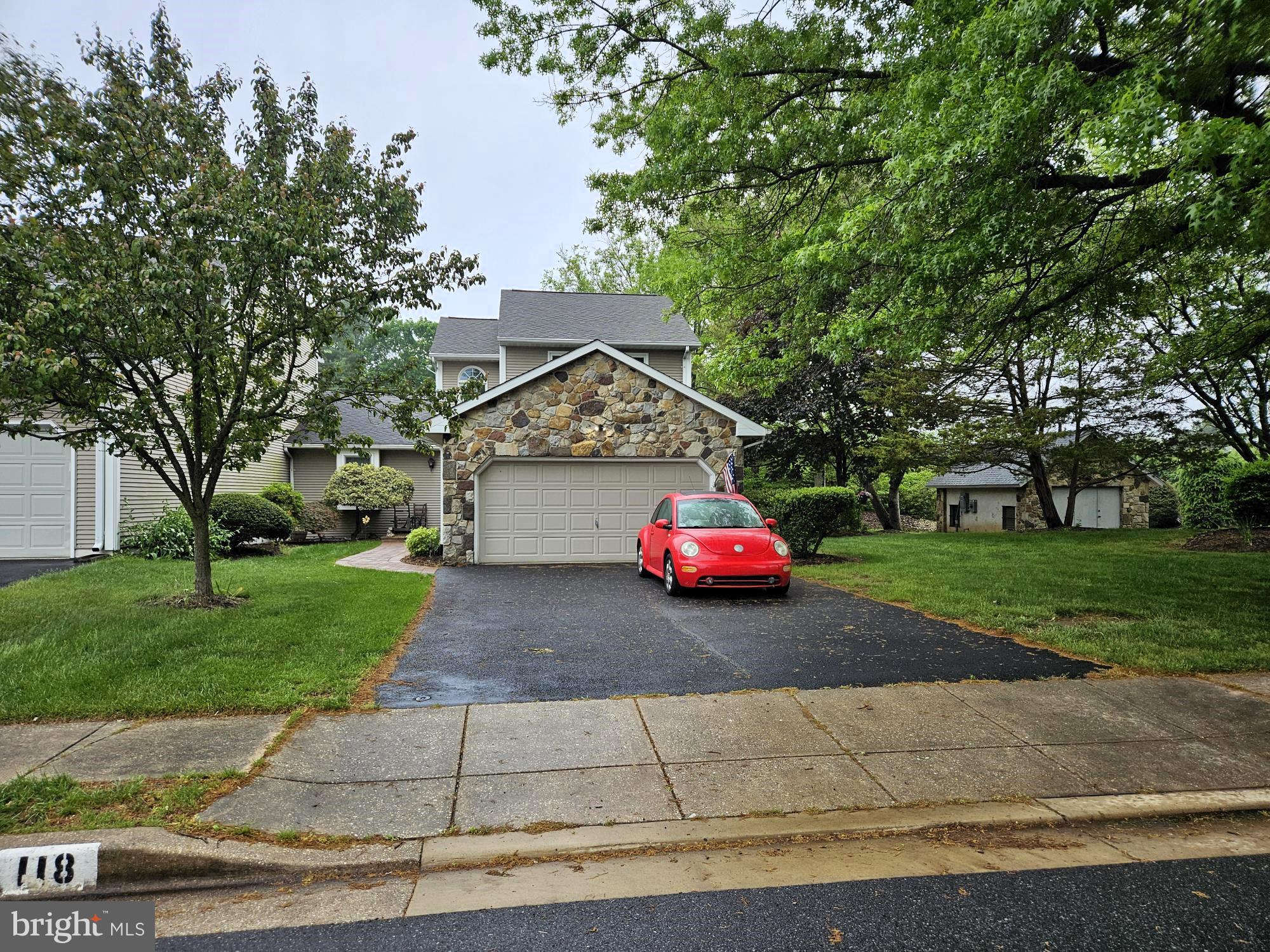 118 Red Pine Circle Newark, DE 19711 - Photo 29 of 32 a car parked in front of a house next to a yard