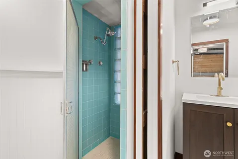 a bathroom with a shower and a sink