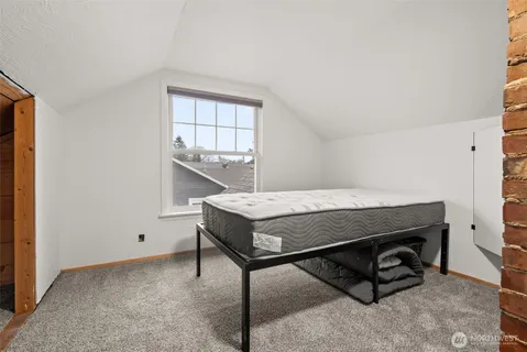 a bedroom with a bed and window