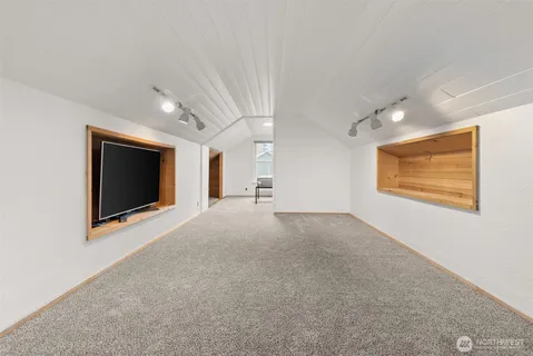a view of a livingroom with an empty space and a flat screen tv