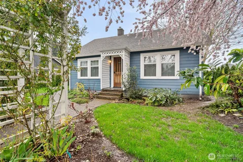 a front view of a house with a garden