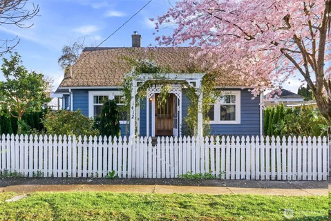 a front view of a house with a garden