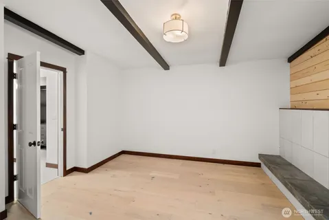 a view of a room with wooden floor and bathroom