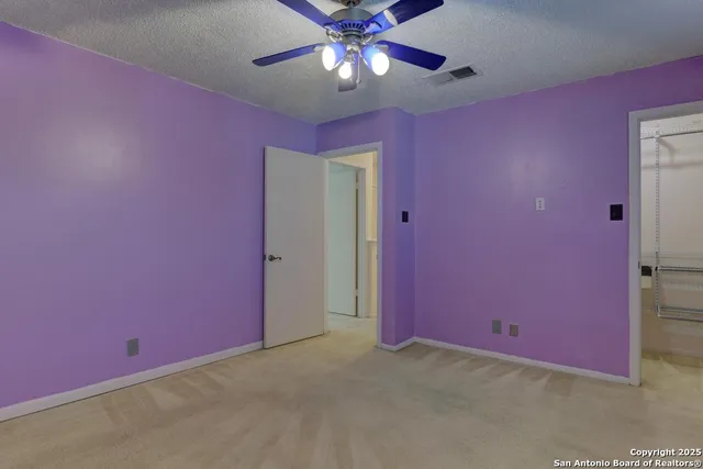 a view of a livingroom with a ceiling fan and window