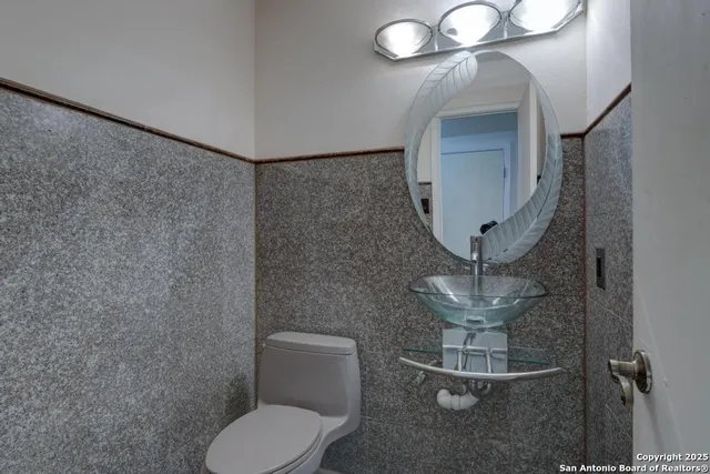 a bathroom with a toilet and a mirror
