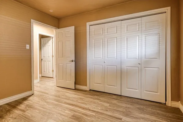 an empty room with wooden floor