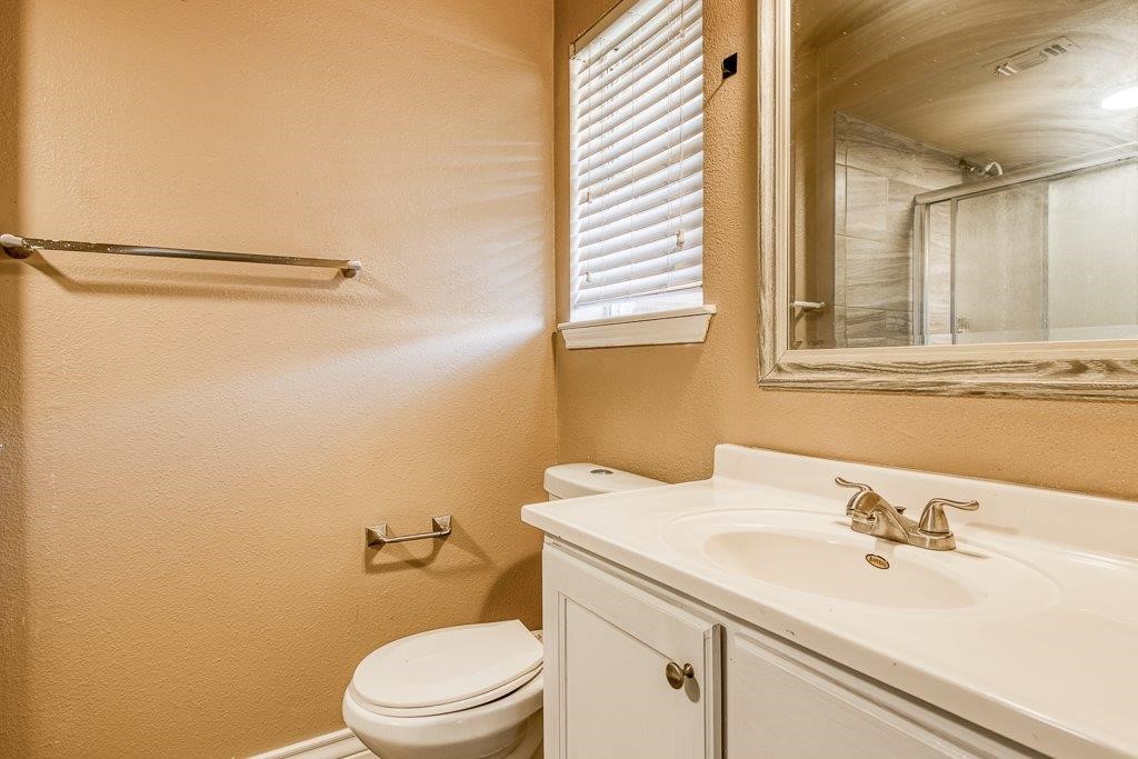 111 Chase Drive Portland, TX 78374 - Photo 21 of 26 a bathroom with a sink a toilet and a mirror