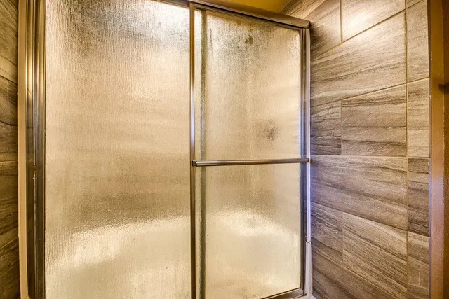 a bathroom with a glass shower door