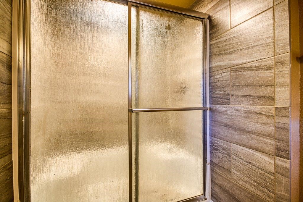 111 Chase Drive Portland, TX 78374 - Photo 22 of 26 a bathroom with a glass shower door