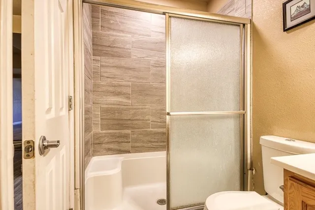 a bathroom with a shower and a toilet