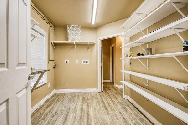 a view of walk in closet with empty racks