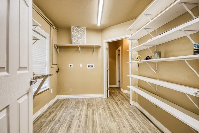 a view of walk in closet with empty racks