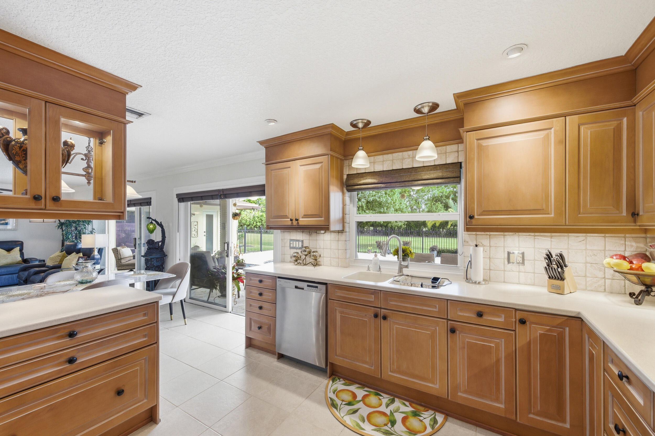4780 Brandywine Drive Boca Raton, FL 33487 - Photo 13 of 43 a kitchen with a sink stove and cabinets