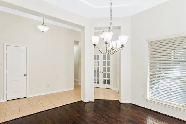 a view of a livingroom with wooden floor and a window