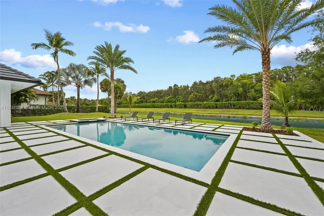 a living room with furniture large window and fireplace