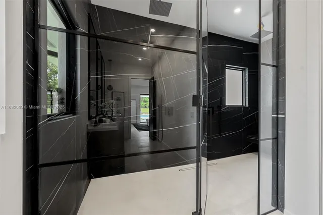 a living room with furniture and paintings on the wall