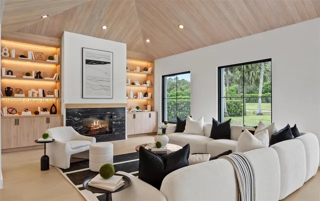 a living room with furniture large window and flat screen tv