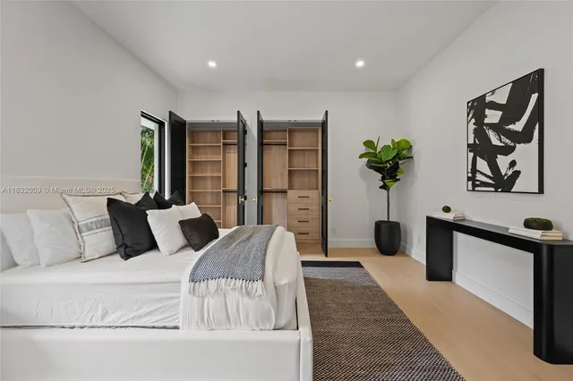 a view of an empty room with wooden floor and windows