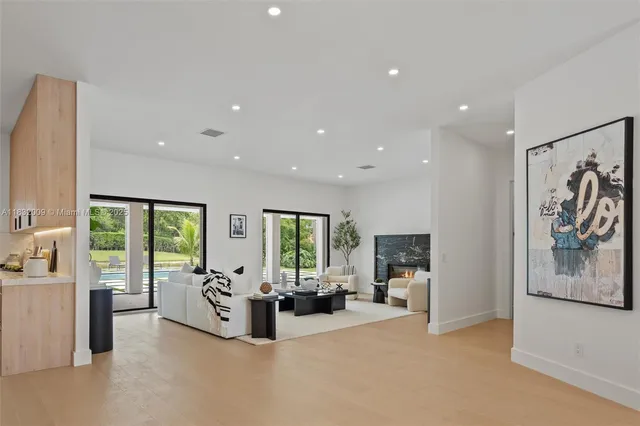a living room with furniture a fireplace and a potted plant