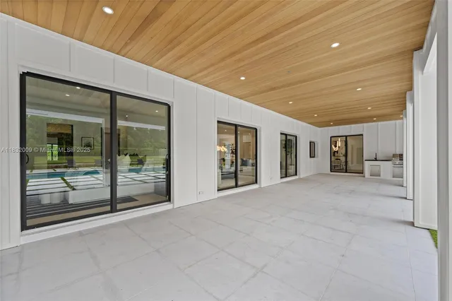 a view of a balcony with chairs and wooden floor